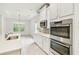 Modern kitchen features stainless appliances, white cabinets, and natural light at 726 Irvine Ranch Rd, Kissimmee, FL 34759