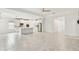 Open-concept living space with a kitchen island, white cabinetry, stainless steel appliances, and tile flooring at 726 Irvine Ranch Rd, Kissimmee, FL 34759