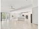 Open-concept living space with a kitchen featuring white cabinets, stainless steel appliances, and tile flooring throughout at 726 Irvine Ranch Rd, Kissimmee, FL 34759