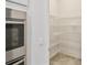 Bright pantry with metal shelving offers ample storage space at 726 Irvine Ranch Rd, Kissimmee, FL 34759