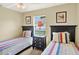 Bright bedroom with twin beds, featuring natural light and decorative accents at 737 Oxford Dr, Davenport, FL 33897