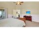 Bedroom with a slider to an outdoor seating area, ensuite bathroom, and tv at 737 Oxford Dr, Davenport, FL 33897