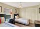 Cozy bedroom with twin beds, a ceiling fan, and natural light from the window at 737 Oxford Dr, Davenport, FL 33897