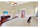 Bright bedroom featuring a king-sized bed, ceiling fan, and en suite bathroom at 737 Oxford Dr, Davenport, FL 33897