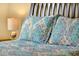 Comfortable bedroom bedspread and pillows with a bedside lamp at 737 Oxford Dr, Davenport, FL 33897