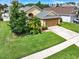 Aerial view of home with manicured lawn and landscaping at 737 Oxford Dr, Davenport, FL 33897