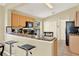 Kitchen with granite countertops, wooden cabinets, stainless steel appliances, and bar seating at 737 Oxford Dr, Davenport, FL 33897