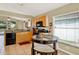 Eat-in kitchen featuring a glass table, stainless steel appliances, and plenty of cabinet space at 737 Oxford Dr, Davenport, FL 33897