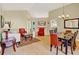 Bright living room with high ceilings, wood floors, stylish furniture, and a formal dining area at 737 Oxford Dr, Davenport, FL 33897