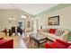 Bright living room with high ceilings, wood floors, stylish furniture, and a formal dining area at 737 Oxford Dr, Davenport, FL 33897