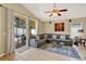 Bright living room with tile floors, neutral walls, and a sliding glass door to an outdoor patio at 737 Oxford Dr, Davenport, FL 33897