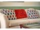 Close up of bright living room showing off the stylish throw pillows on a white sofa at 737 Oxford Dr, Davenport, FL 33897