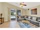 Living room featuring tile flooring, neutral paint, with access to the screened-in pool area at 737 Oxford Dr, Davenport, FL 33897