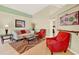 Bright living room with high ceilings, wood floors, stylish furniture, and a formal dining area at 737 Oxford Dr, Davenport, FL 33897
