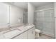 Bathroom features double sinks, granite countertops, and tiled glass shower at 7554 Sunflower Cir, Kissimmee, FL 34747