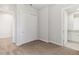 Neutral bedroom featuring carpet floors, closet with sliding doors, and an ensuite bathroom at 7554 Sunflower Cir, Kissimmee, FL 34747