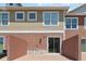 Exterior view of patio with red brick pavers, a red privacy wall and sliding door at 7554 Sunflower Cir, Kissimmee, FL 34747