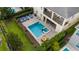Stunning aerial view of a home's backyard featuring a pool, spa, lounge area, and lush landscaping at 7616 Brookhurst Ln, Kissimmee, FL 34747