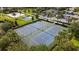 Community sports facilities with tennis and volleyball courts, and a basketball area surrounded by lush landscaping at 7616 Brookhurst Ln, Kissimmee, FL 34747