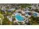 Aerial view of a community waterpark with pools, waterslides, splash pads, and lounge areas at 7616 Brookhurst Ln, Kissimmee, FL 34747