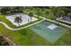 Aerial view of basketball and sand volleyball courts surrounded by green space and palm trees at 7616 Brookhurst Ln, Kissimmee, FL 34747