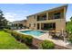 Enjoy outdoor living with a sparkling pool, hot tub, patio, lounge chairs, and professionally landscaped yard at 7616 Brookhurst Ln, Kissimmee, FL 34747