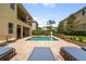 Inviting backyard with pool, hot tub, patio, lounge chairs, and manicured landscaping, ideal for relaxation and enjoyment at 7616 Brookhurst Ln, Kissimmee, FL 34747