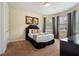 Cozy bedroom featuring a comfortable bed, soft lighting, and a serene atmosphere with carpeted floors at 7616 Brookhurst Ln, Kissimmee, FL 34747