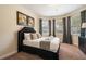 Cozy bedroom with a plush bed, decorative pillows, and a bay window for natural light at 7616 Brookhurst Ln, Kissimmee, FL 34747