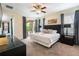 Spacious bedroom with a comfortable bed, a ceiling fan, and sliding door access to outdoor patio at 7616 Brookhurst Ln, Kissimmee, FL 34747