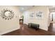 Elegant entryway with hardwood floors, decorative mirror, and view of the game room at 7616 Brookhurst Ln, Kissimmee, FL 34747