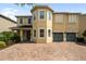 Charming two-story home with a two-car garage and brick paved driveway at 7616 Brookhurst Ln, Kissimmee, FL 34747