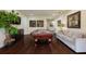 Inviting game room with a pool table, sofa, television, and stylish decor at 7616 Brookhurst Ln, Kissimmee, FL 34747