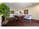 Bright game room features a pool table, comfortable sofa, and stylish decor at 7616 Brookhurst Ln, Kissimmee, FL 34747