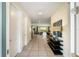 Bright and spacious hallway with tiled floors, leading to the living room and kitchen at 7616 Brookhurst Ln, Kissimmee, FL 34747