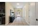 Bright and spacious hallway with tiled floors, leading to the front door and kitchen at 7616 Brookhurst Ln, Kissimmee, FL 34747