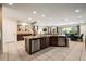 Open concept kitchen with granite countertops, stainless steel appliances, and large island at 7616 Brookhurst Ln, Kissimmee, FL 34747