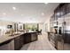 Bright kitchen featuring stainless steel appliances, granite counters and open concept design to the living area at 7616 Brookhurst Ln, Kissimmee, FL 34747