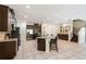 Spacious kitchen with stainless steel appliances, granite countertops, dark wood cabinets, and eat-in island at 7616 Brookhurst Ln, Kissimmee, FL 34747