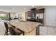 Spacious kitchen island with granite countertop and seating, flowing into the living area at 7616 Brookhurst Ln, Kissimmee, FL 34747