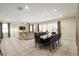 Open living and dining area with sliding glass doors leading to outdoor patio and neutral decor at 7616 Brookhurst Ln, Kissimmee, FL 34747