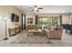 Comfortable living room with large windows, neutral color palette, and sliding glass doors to the outdoor space at 7616 Brookhurst Ln, Kissimmee, FL 34747