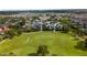 Wide shot of a park with a large grassy area, soccer goals, and a waterpark and residences in the background at 7616 Brookhurst Ln, Kissimmee, FL 34747
