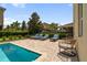 Relaxing poolside with comfortable lounge chairs on a brick-paved patio perfect for enjoying sunny days at 7616 Brookhurst Ln, Kissimmee, FL 34747