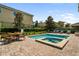Beautiful backyard pool and spa with surrounding patio furniture and landscaping at 7616 Brookhurst Ln, Kissimmee, FL 34747