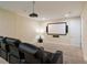 Home theater room equipped with comfortable seating, a projector, and screen at 7616 Brookhurst Ln, Kissimmee, FL 34747