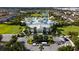 Stunning aerial view of a resort-style waterpark with slides, pools, and a clubhouse surrounded by lush landscaping at 7616 Brookhurst Ln, Kissimmee, FL 34747