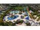 A high aerial view of a waterpark featuring a colorful array of pools and slides, perfect for Gathering fun at 7616 Brookhurst Ln, Kissimmee, FL 34747