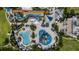 Overhead shot of a community waterpark with slides, pools, lounge areas and meticulously maintained landscaping at 7616 Brookhurst Ln, Kissimmee, FL 34747