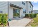 A small back patio with an awning leads to a grassy common area at 955 Grandin St, Davenport, FL 33837